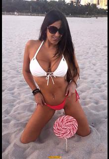 Claudia Romani cleavage in bikini on a beach Claudia Romani cleavage in bikini on a beach