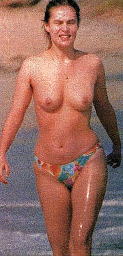 Emmanuelle Seigner topless on a beach