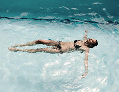 Abi Penhale in black bikini in a pool