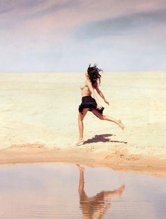 Laetitia Casta running topless on a beach