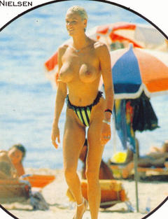 Danish actress Brigitte Nielsen topless on a beach paparazzi photo