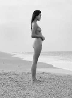 Chrissy Teigen fully nude on a beach