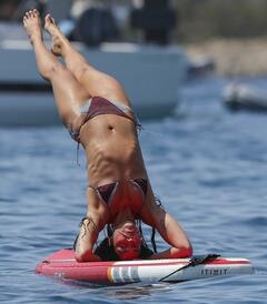 Dua Lipa doing paddleboard yoga in bikini in Ibiza - August 2025
