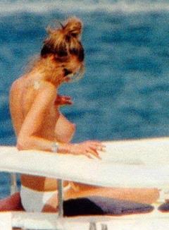 Elle Macpherson sunbathing topless on a yacht