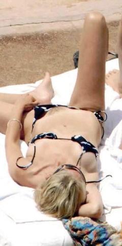 Sharon Stone flashing her hairy pussy on a beach in Pantelleria