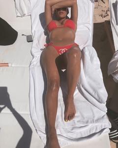 Kim Kardashian sunbathing in red bikini