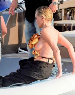 Sharon Stone wardrobe malfunction (topless) in black and gold flower top dress in southern France