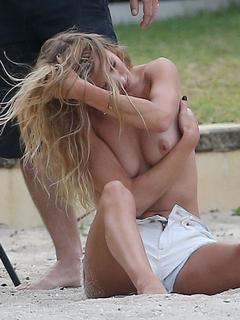 Rosie Huntington-Whiteley topless on a beach