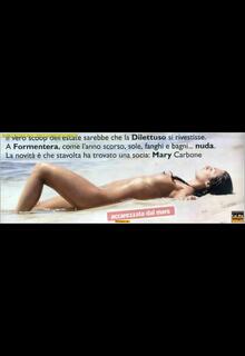 Rosy Dilettuso lying topless on a beach