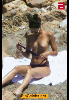 Rocio Morales sunbathing topless on a beach paparazzi photo