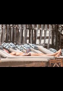 Kristen Hancher sunbathing tpless on the beach