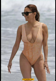 Eva Longoria cleavage in a swimsuit on the  beach in Marbella