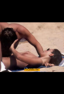 Monica Bellucci topless on a beach paparazzi photo