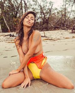 Gigi Paris braless on a beach