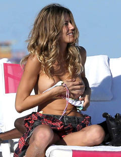 Martha Graeff changing on a beach shows her breasts