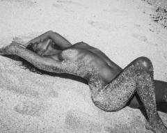 Sundal Roy lying nude on a beach black-&-white image