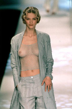 Carmen Kass braless in fishnet top runway image