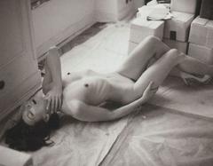 Milla Jovovich lying naked black-&-white photo