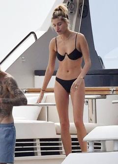 Hailey Baldwin in black bikini on a yacht