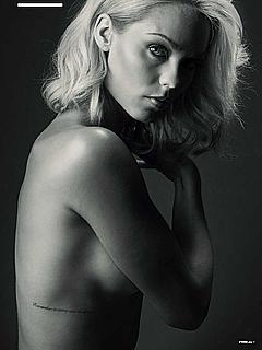 Blonde Laura Vandervoort topless but covered