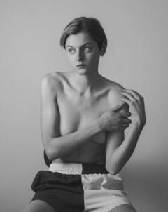 Emma Corrin topless but covered black-&-white image