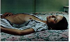 Nicole Trunfio liyng topless