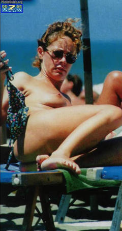 Italian actress Elena Sofia Ricci sunbathing topless on a beach