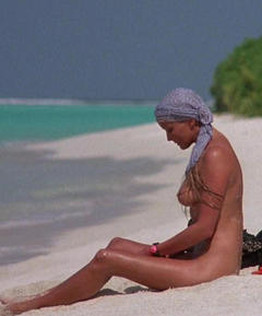 Bo Derek sitting nude  on a beach in Ghosts can't do it