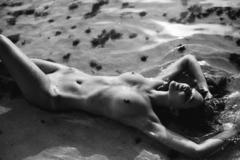 Lisa Marie Bosbach lying fully nude on a beach black-&-white image