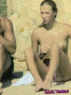 Russian model and actress Ludmilla Radchenko topless on a beach