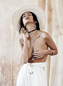 Emily Ratajkowski topless but covered in white pants