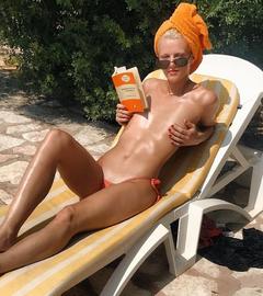 Katie Kuips sunbathing topless but cover her tit
