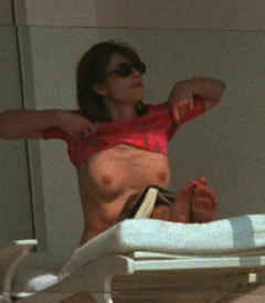 Elizabeth Hurley changing on a beach shows her nude tits