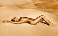 Alessia Marcuzzi lying fully nude on a sand