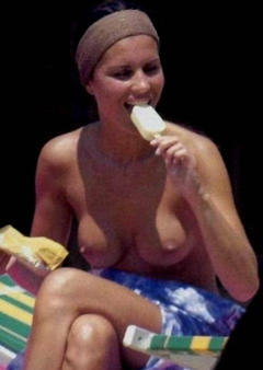 Antonella Mosetti topless eating ice cream on a beach