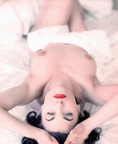 Sherilyn Fenn topless on a bed