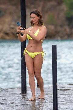 Chanelle Hayes in yellow bikini at a beach in Palma