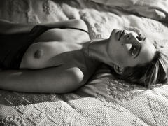 Tiiu Kuik topless on a bed