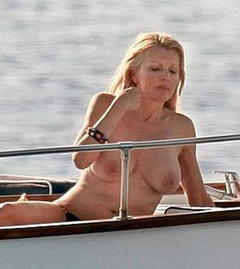 Rita Rusic sunbathing topless on a boat