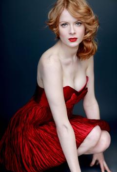 Redhead Emily Beecham in red dress