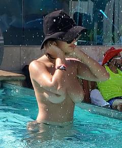Busty Tao Wickrath topless at a pool party
