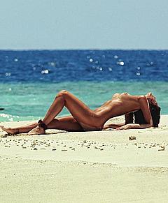 Isabeli Fontana lying nude on a beach