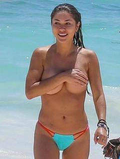 Arianny Celeste topless on a beach cover her tits