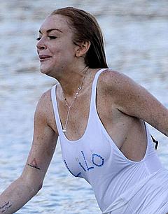 Lindsay Lohan in wet see through dress on a beach