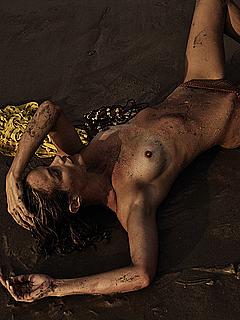 Carolyn Murphy topless on a beach