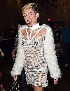 Miley Cyrus topless with pasties under fishnet dreee