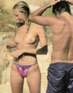 Ludmilla Radchenko topless on a beach paparazzi photo