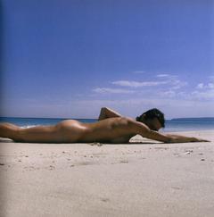 Ulrike Folkerts lying naked on a beach