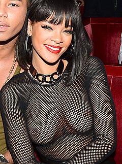 Singer Rihanna topless under see through fishnet top