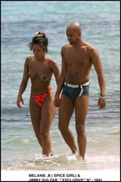 Melanie Brown topless on a beach paparazzi image